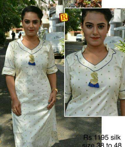 Fancy white kurti with work by Roshni Boutique