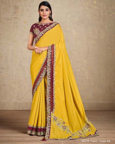 A luxurious and exquisite silk yellow designer saree with hand work