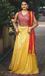 Presenting yellow lehenga with mirror work