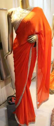 Party Wear Plain Orange Saree With Silver Lace by Madhukunj