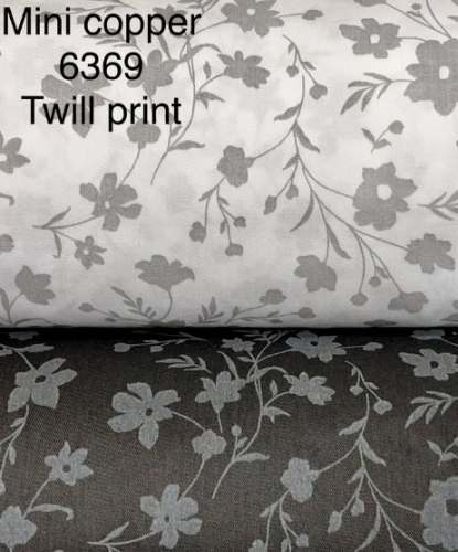 Cream And Black color Printed Copper Twill Fabric